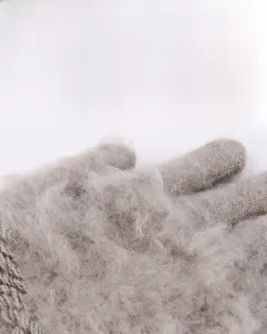 Close-up of the thick grey fleece lining inside the knitted winter gloves for warmth.