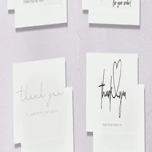 Detailed macro view of minimalist white thank you cards with elegant scripts