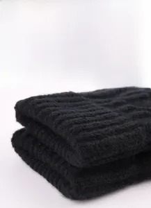 Detail view showing the double-layer elastic cuff of these knitted winter gloves.