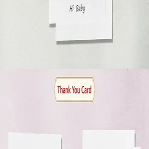 Detail of minimalist white thank you card with Hi Baby text on textured background.
