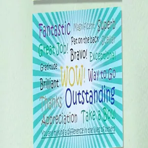 Close-up of square encouragement card with blue sunburst pattern and positive words.
