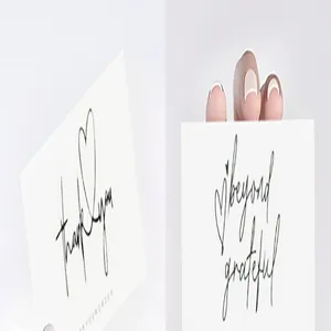 Close-up of minimalist thank you cards with elegant script and heart designs.