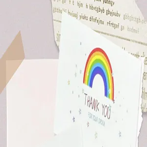 Close-up of a decorative thank you card with a colorful rainbow and stars design