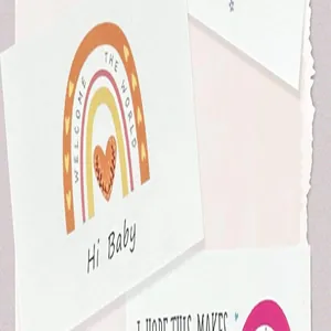 Close-up of rainbow and heart design on premium English thank you card for babies