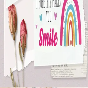 Close-up detail of a rainbow greeting card with I hope this makes you smile text
