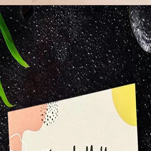Close-up of artistic thank you card with abstract patterns on textured black surface.