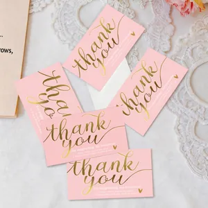 Close-up detail of pink small business thank you cards with elegant gold foil text