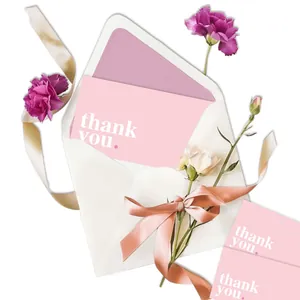 Elegant minimalist pink thank you greeting card with white envelope and fresh flowers