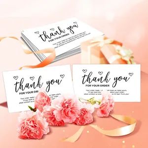 Detail view of premium white thank you cards with elegant script and carnation flowers