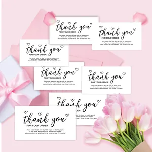Detailed view of elegant white 'Thank You For Your Order' cards in pink floral setting.
