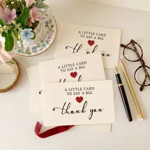Close-up of high-quality Thank You cards with elegant typography and red heart detail