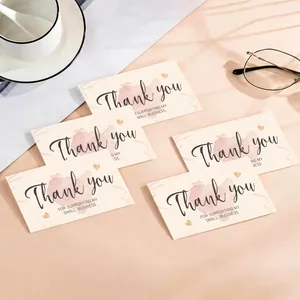 Detailed view of elegant thank you cards with pink watercolor heart and black script