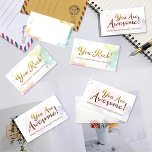 Detail of premium watercolor thank you cards with gold foil lettering and stationery props.