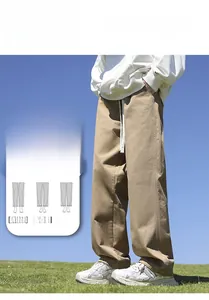 Detailed view of men's loose straight-leg cotton casual trousers in khaki outdoor
