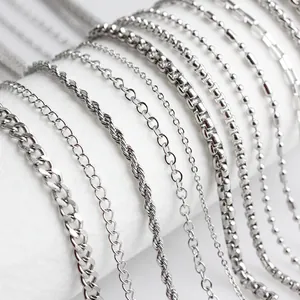 Close-up macro detail of various stainless steel chain styles for DIY jewelry making