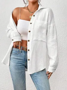 Front view detail of a women's white textured cotton shirt with drop shoulder design