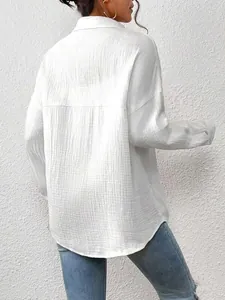 Back view of a women's white long-sleeve blouse featuring textured crinkle fabric.