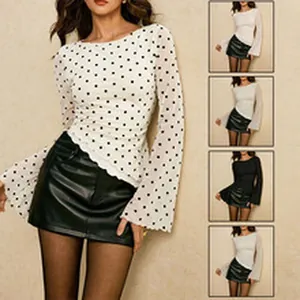 Detailed view of stylish white polka dot blouse featuring elegant bell sleeves design