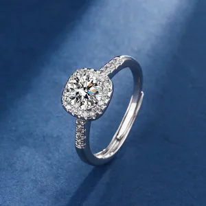 Close-up of a silver ring featuring a round brilliant center stone with a square halo.