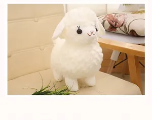 Detailed macro shot of a soft white plush lamb toy standing on a cream leather chair