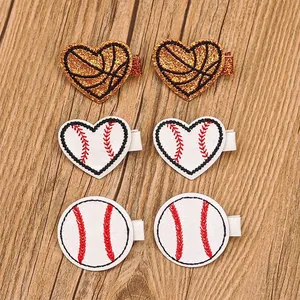 Detailed view of three pairs of sports-themed heart and round baseball hair clips