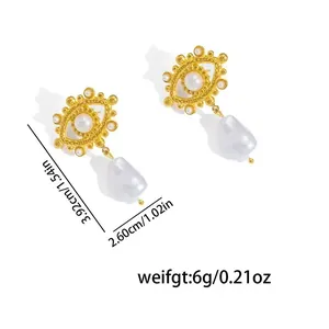 Close-up detail of vintage gold evil eye earrings with pearls and baroque drops