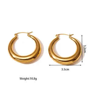Detailed view of polished gold-tone titanium steel hollow chunky hoop earrings