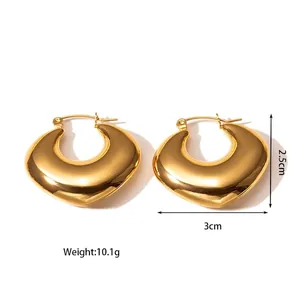 Chunky gold heart-shaped titanium steel hollow hoop earrings on white background