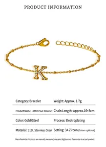 Detail view of a 316 titanium steel bracelet with a zircon-encrusted letter K charm.