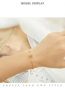 Dainty gold chain bracelet with a sparkling zircon letter X charm for women.