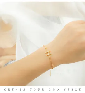 Close-up of a gold-plated letter H bracelet with sparkling cubic zirconia