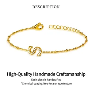 Detail view of gold titanium steel bracelet with sparkling zircon inlaid letter S charm