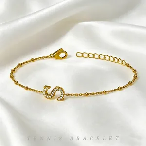 Elegant gold-plated titanium steel bracelet featuring a zircon-encrusted letter S charm