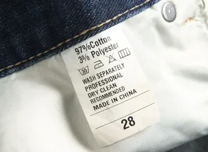 Macro view of textile care label on American streetwear men's vintage straight denim jeans