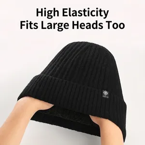 Detail showing the high elasticity and ribbed knit texture of a thick black winter beanie.