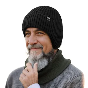 Close-up view of a warm black knitted winter beanie for seniors worn by an elderly man.
