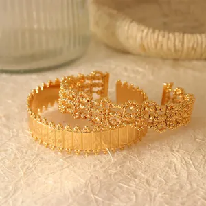 Macro view showing the intricate detail of gold-plated hollow mesh and geometric open bracelets.
