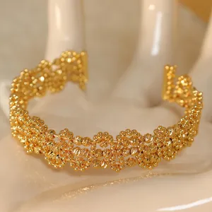 Close-up of the intricate gold-plated beaded texture and geometric hollow design