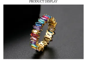 Macro view of a vibrant rainbow baguette-cut cubic zirconia eternity ring in gold plating