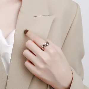 Detailed view of a silver infinity spinning ring with anti-anxiety beads on finger
