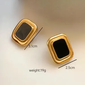 Detailed view of gold rectangular titanium steel earrings with 3.1cm x 2.5cm dimensions