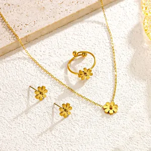 Macro detail of 18K gold plated titanium steel daisy flower necklace ring earrings set