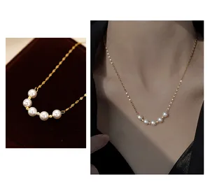 Close-up and model shot of a delicate gold smile pearl necklace collarbone chain.