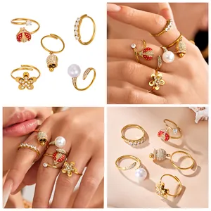 Multi-style gold ring set featuring zircon ladybug, bell, flower, and pearl details.