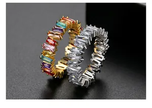 Close-up of rainbow and white baguette cut zircon eternity rings in gold and silver
