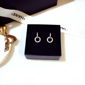 Close-up detail of sparkling pave-set double circle earrings in black jewelry box.