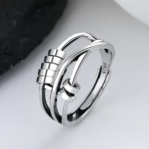 Close-up of a silver spinning anxiety ring with movable beads and S925 hallmark.