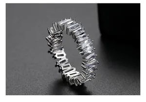 Close-up of a silver eternity ring with baguette-cut clear cubic zirconia stones.