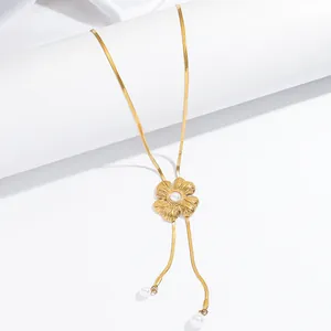 Detailed view of gold floral tassel necklace with elegant faux pearls and snake chain