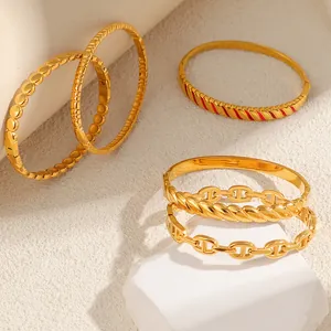 Detailed view of gold-plated titanium steel bangles with various stylish designs.